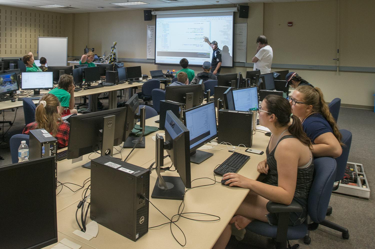 Technology, Art & Design students in a classroom, sitting in front of computers while a professor lectures